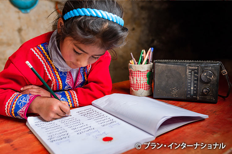 写真：コロナ禍中ラジオ放送で学ぶ女の子（ペルー）