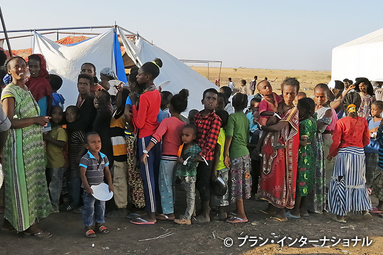 写真：食料配給の列に並ぶ人々（スーダン）