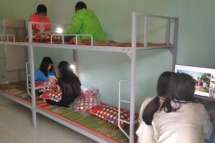ベッドとPCが備わった学生寮の室内 / ©プラン・インターナショナル