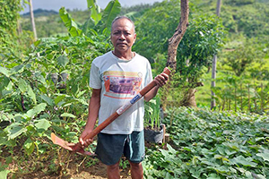 支給された農具を使って畑を耕す男性 / ©プラン・インターナショナル