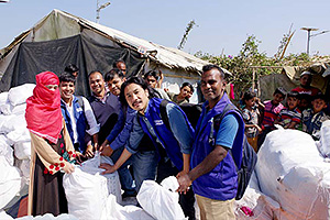 難民キャンプで防災用品を配布するプラン職員 / ©プラン・インターナショナル