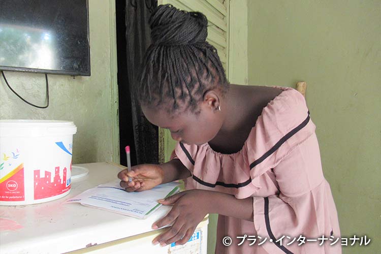 写真：返事を書くチャイルド