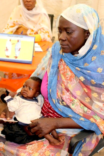 深刻な栄養不良状態の6カ月の息子を抱く母親