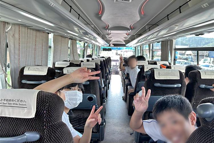 写真：遠足に向かうバスのなかで（小学校遠足）