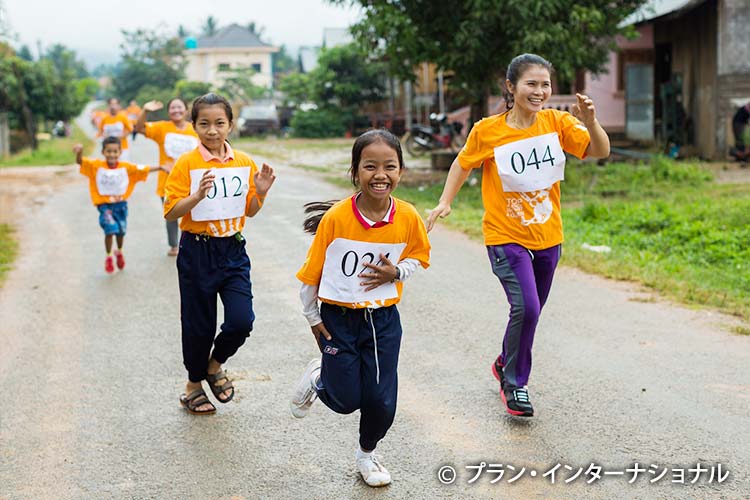 写真：「女性に対する暴力撤廃の国際デー」を記念して走るラオスの女の子と女性